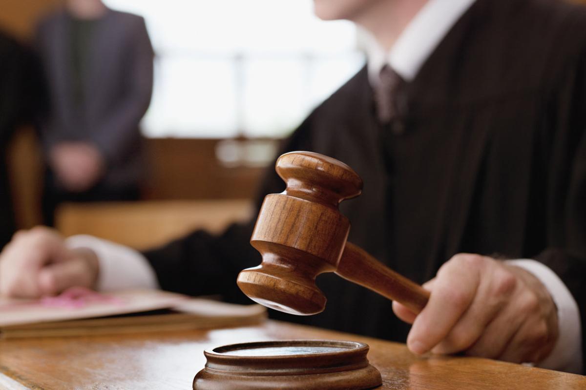 Judge behind bench banging his gavel.