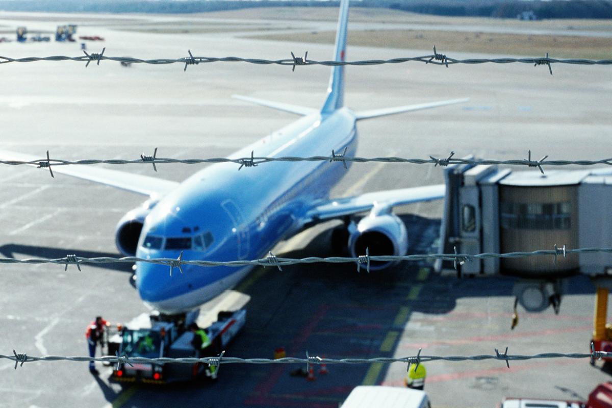 Aircraft image framed by barbed wire.
