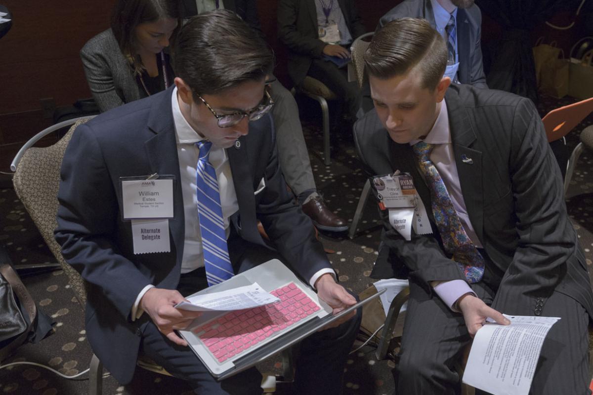 Two physicians gather at the HOD meeting. 