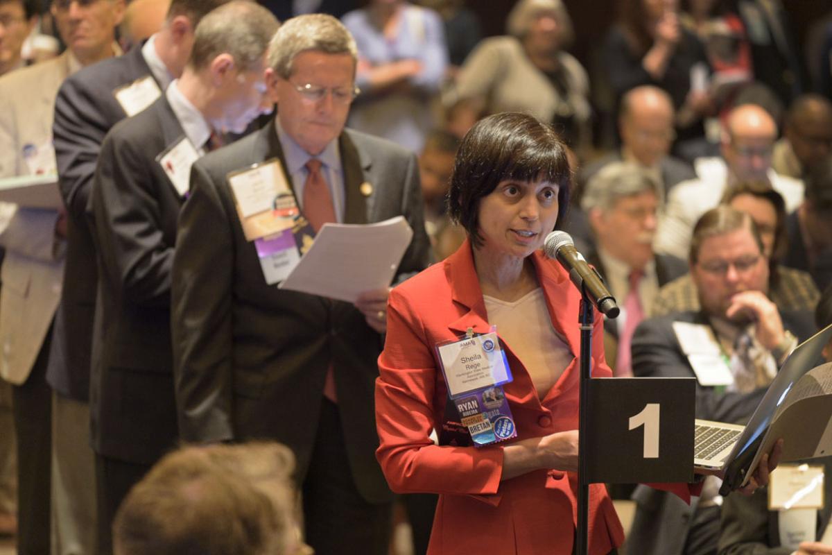 Physicians standing in line to have their voices heard at meeting. 
