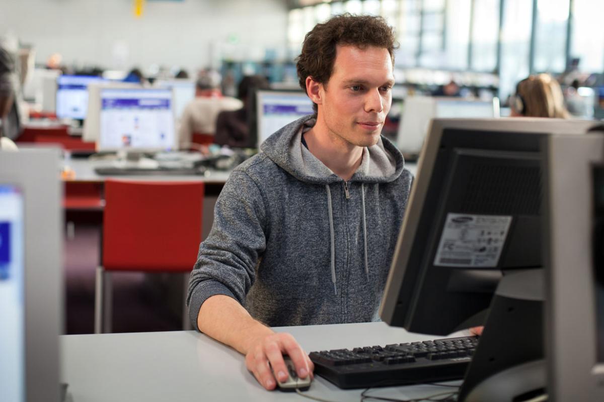 Student working at desktop computer.