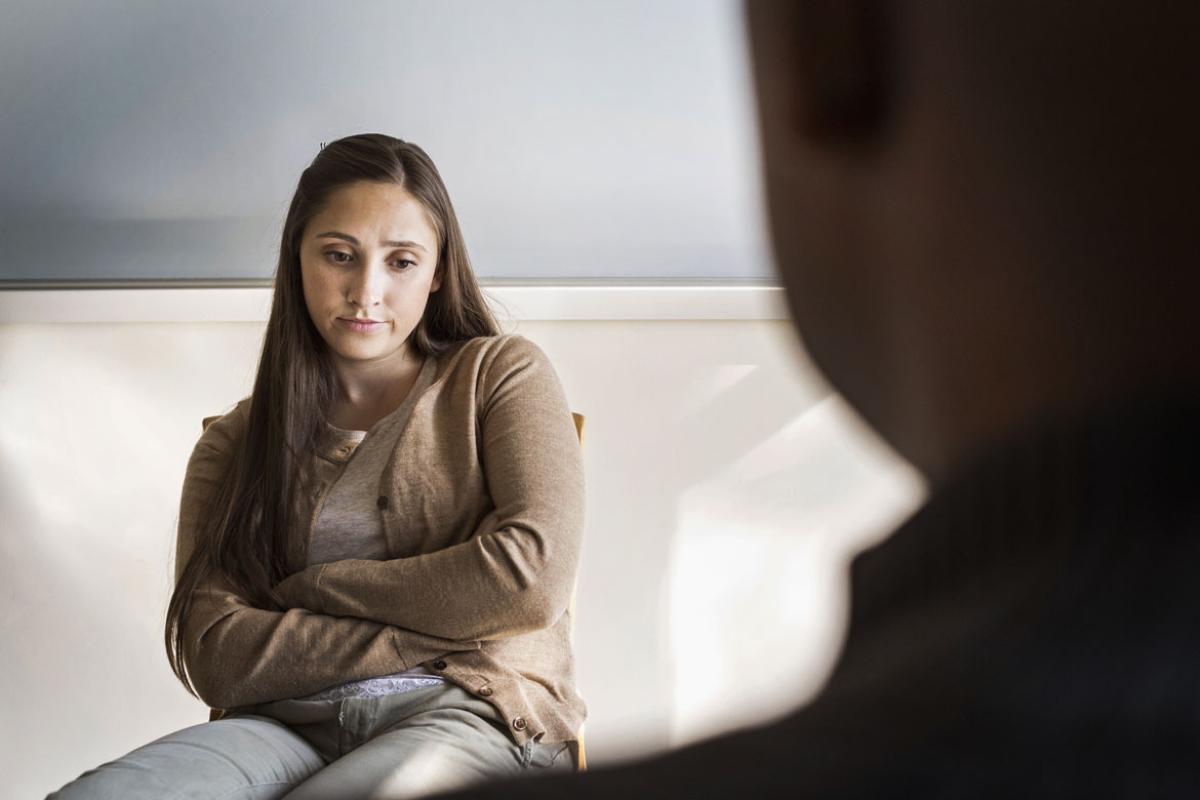 Disgruntled teen with adult caregiver. 