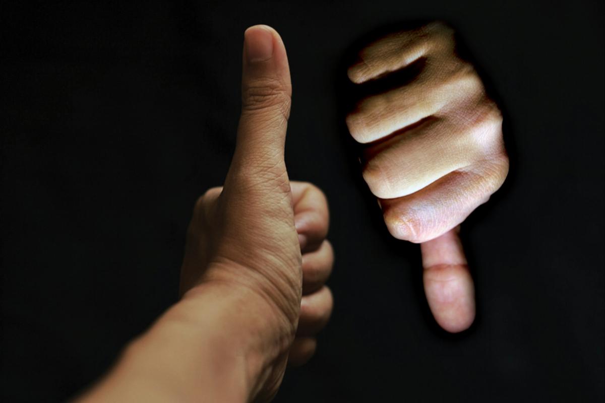 Two hands, one thumbs up, the other thumbs down.