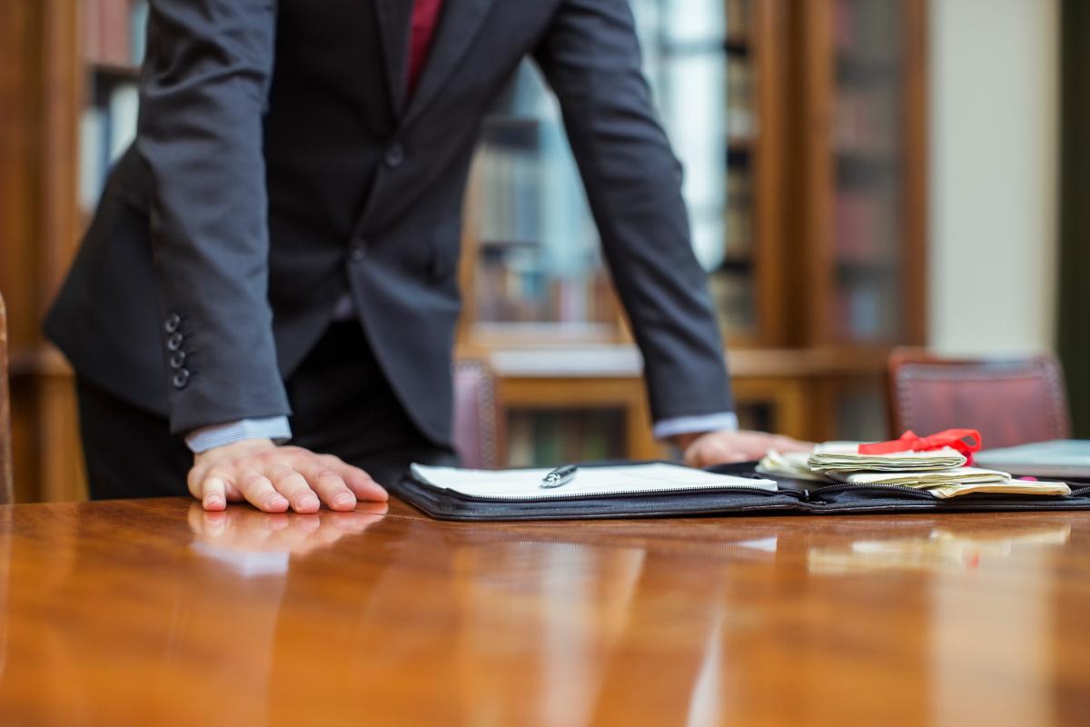 Person standing up with hands on table