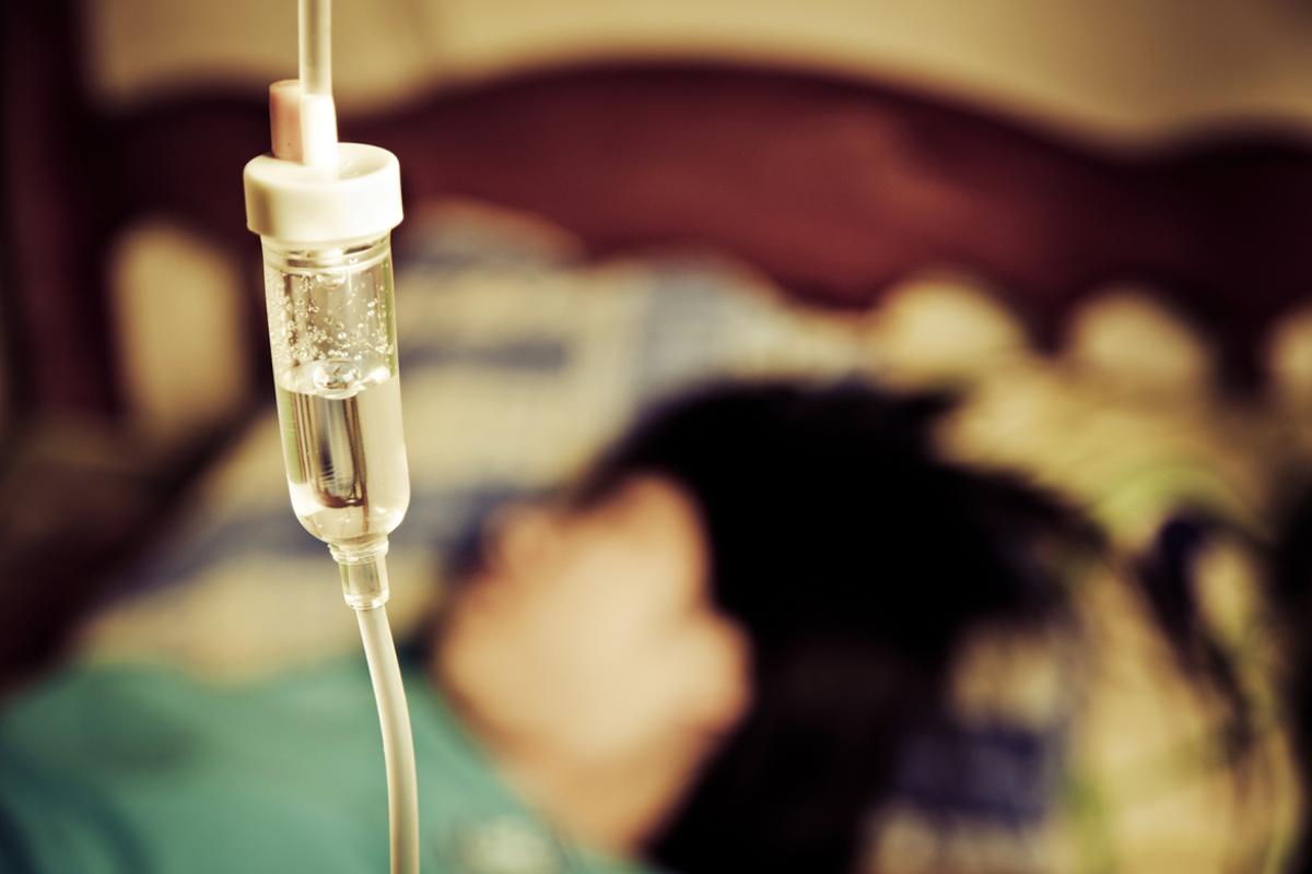 Patient in bed with IV closeup