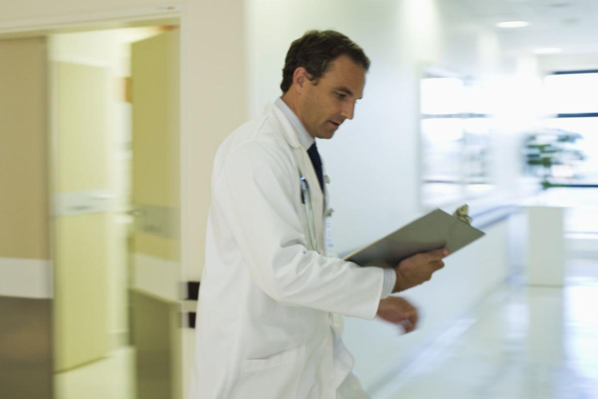 Doctor walking fast in hospital hallway