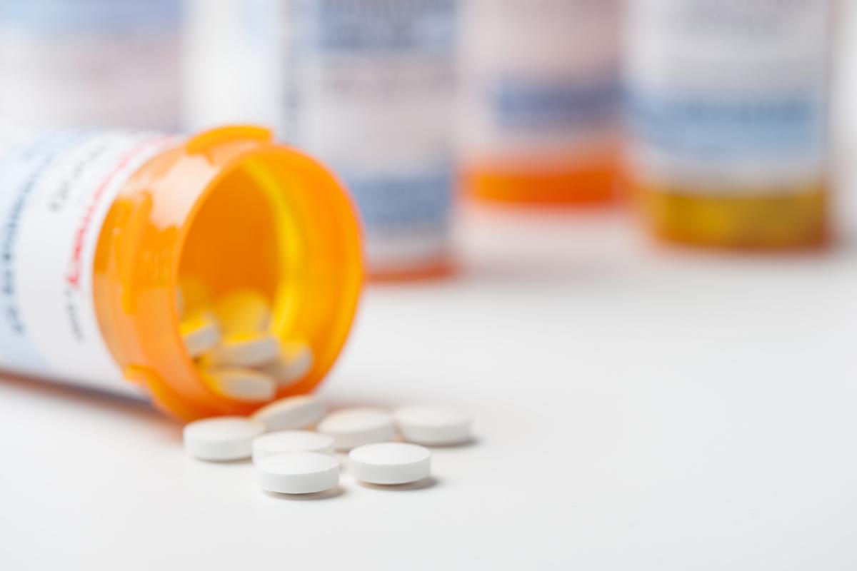 Bottle containing spilled pills.