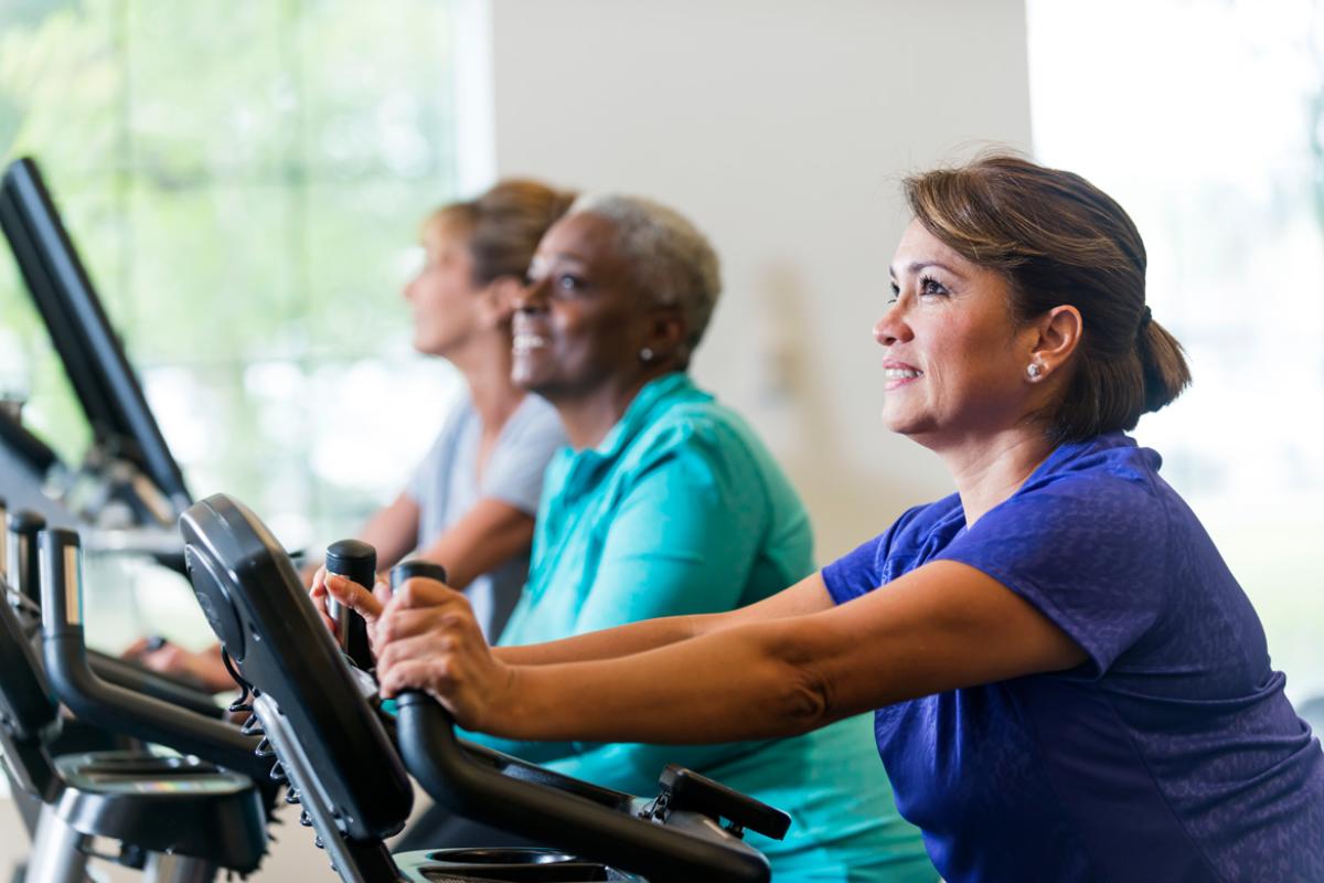 Women exercising and smiling.