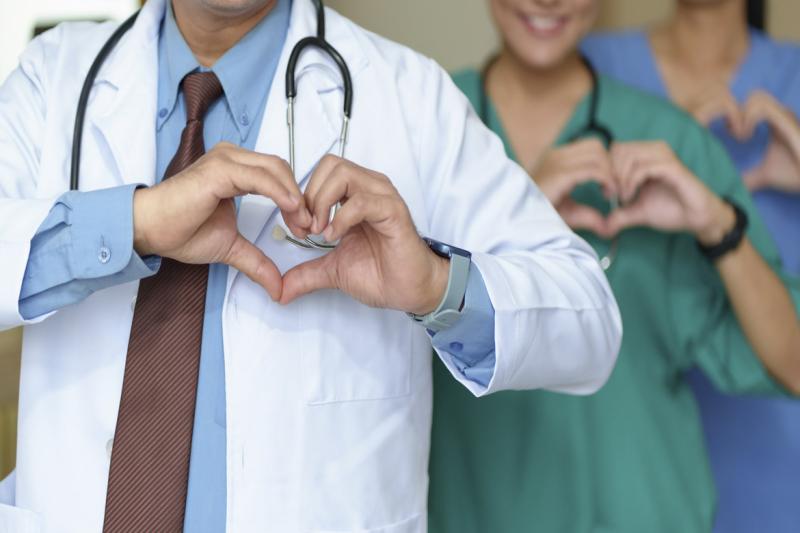 Physician holding hands in shape of a heart